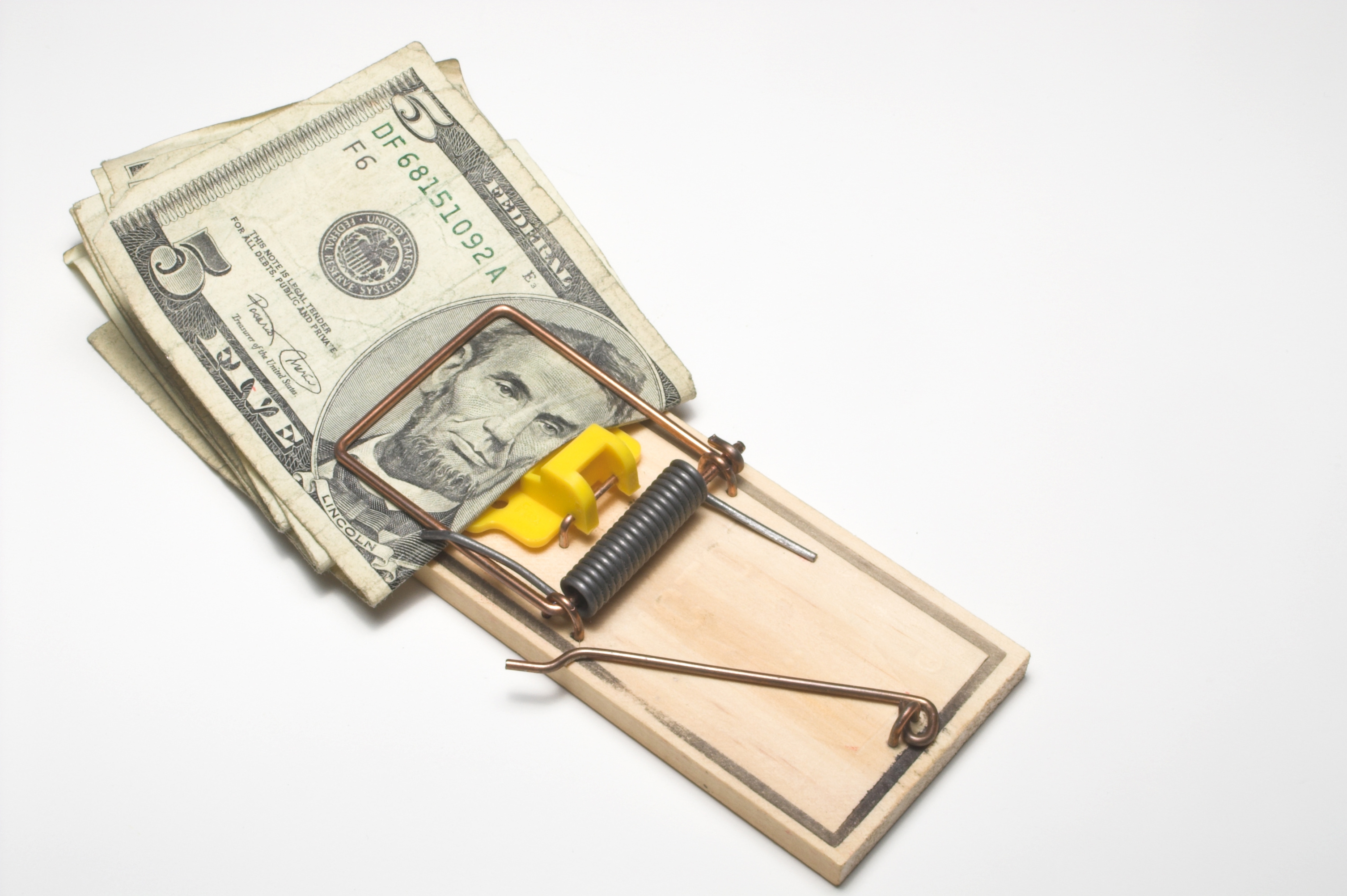 Money trapped in a mousetrap. Financial concept.